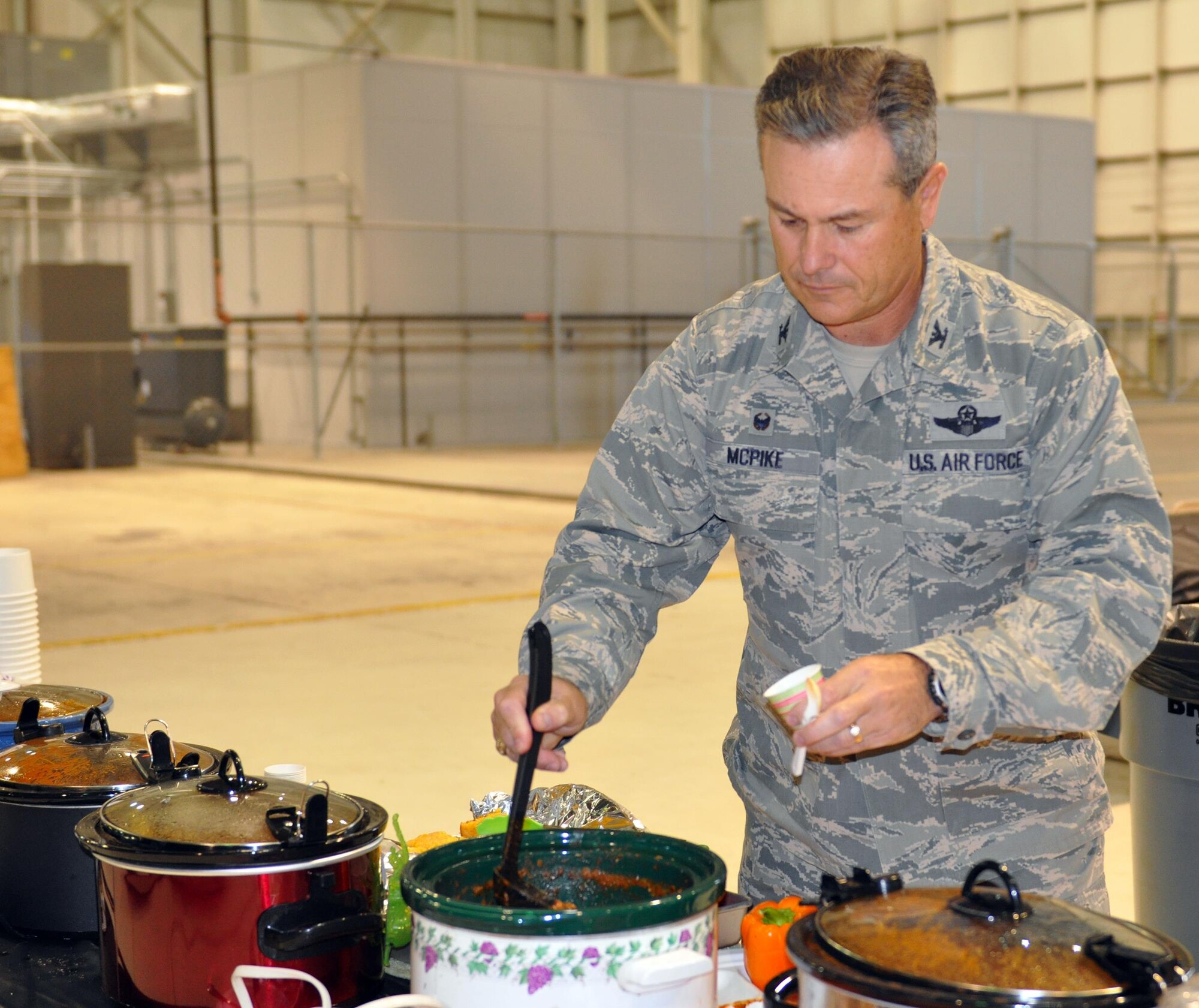 Col. Craig McPike, 445th Operations Group commander, prepares to sample one of 17 pots of chili while serving as a judge during the 445th Airlift Wing’s 16th Annual Chili Cook-off Oct. 27, 2016. The event raised $400 for the Combined Federal Campaign. (U.S. Air Force photo/Stacy Vaughn)    