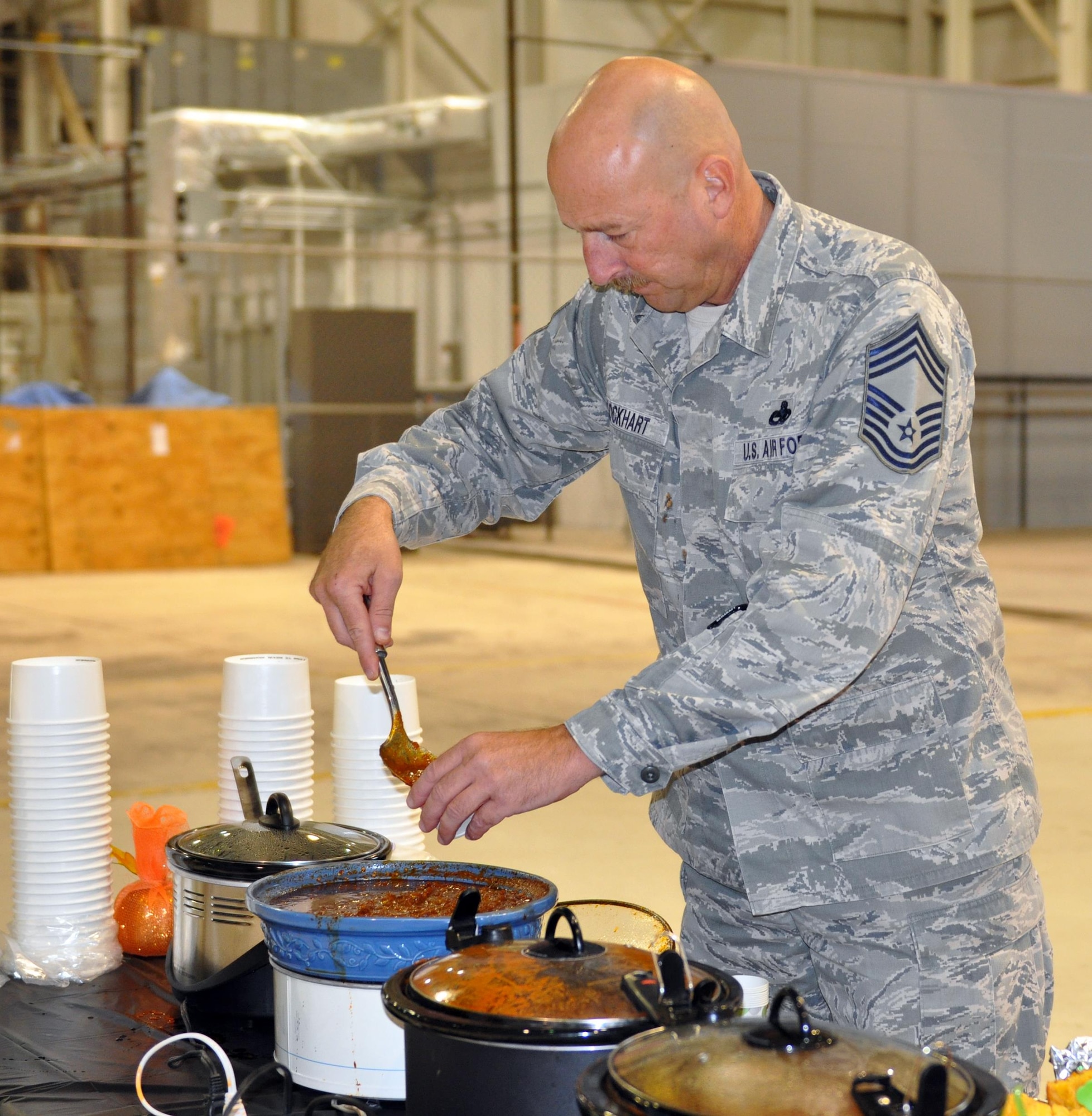 Chief Master Sgt. Mark Lockhart, 445th Maintenance Group superintendent, prepares to sample one of 17 pots of chili while serving as a judge during the 445th Airlift Wing’s 16th Annual Chili Cook-off Oct. 27, 2016. The event raised $400 for the Combined Federal Campaign. (U.S. Air Force photo/Stacy Vaughn)    