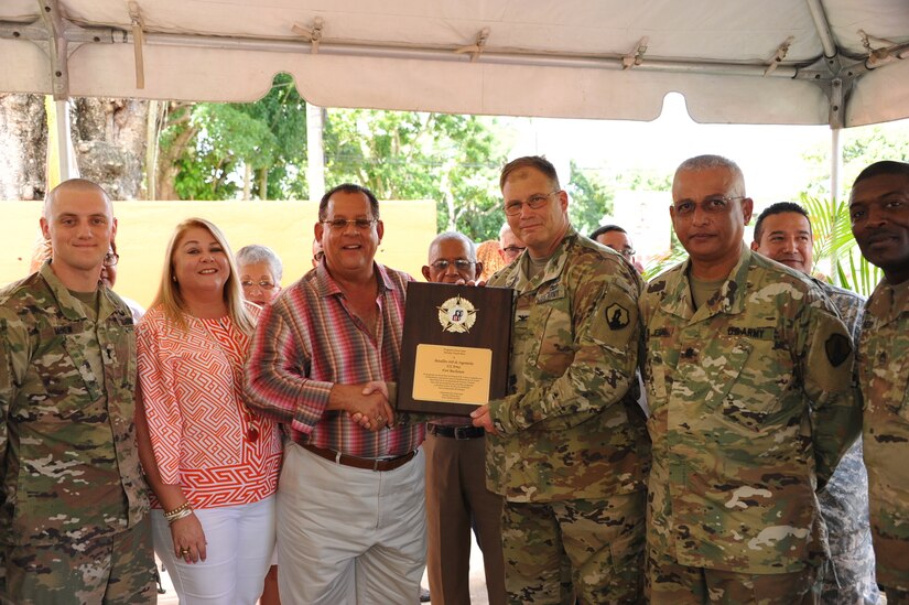 Mr. Carlos Lopez Rivera, Dorado city Mayor presents a plaque of appreciation to the 448th Engineer Battalion for their hard work and dedication. The US Army Reserve Soldiers assisted the community by renovation an old elementary school into a center for the Early Head Start Program. The inauguration of the 'Tesoro Infantil' took place on October, 26.