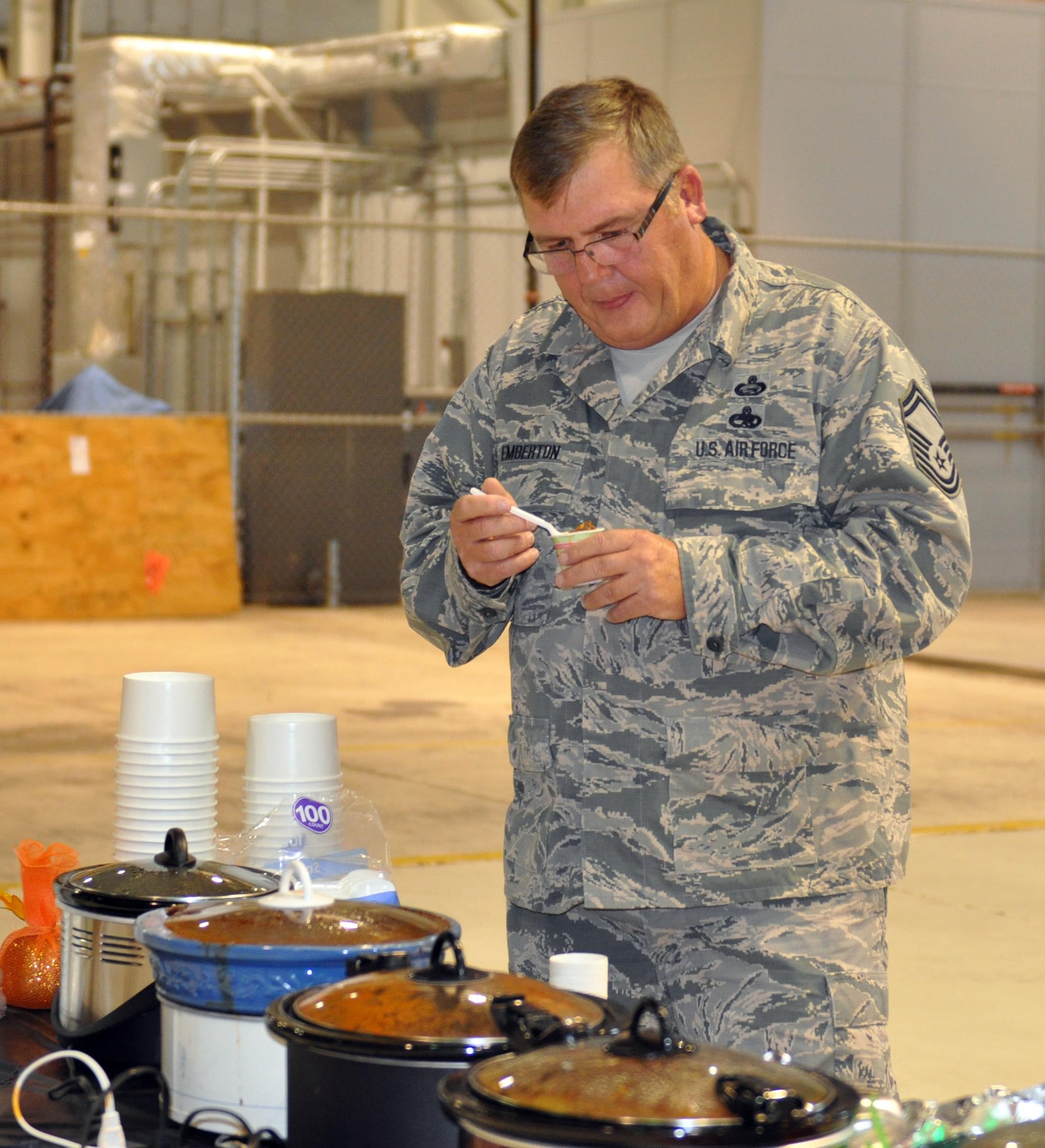 Senior Master Sgt. Timothy Emberton, 445th Force Support Squadron chief of education and training, samples one of 17 pots of chili while serving as a judge during the 445th Airlift Wing’s 16th Annual Chili Cook-off Oct. 27, 2016. The event raised $400 for the Combined Federal Campaign. (U.S. Air Force photo/Stacy Vaughn)    