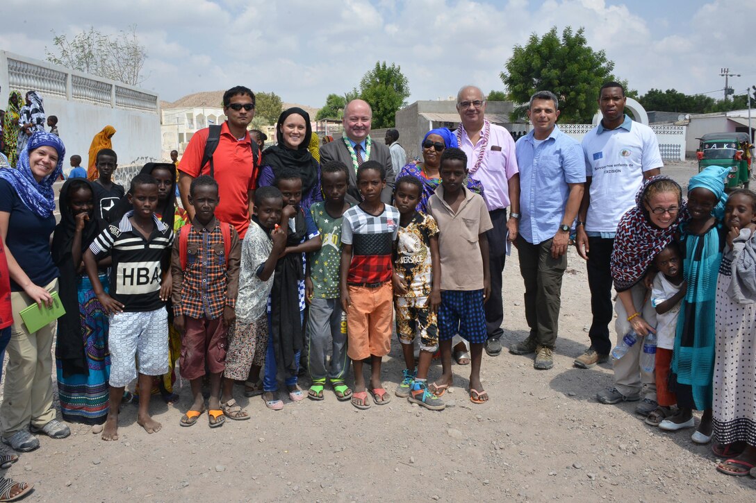 Tadjoura, Djibouti – Civil Affairs Soldiers with the 418th Civil Affairs Battalion and C/Co 411th Civil Affairs Battalion, local leaders, and dignitaries from the European Union gather with children for a photo after a eradication of female genital mutilation conference here on October 26, 2016.  More than 200 Djiboutians attended the conference as 20 females signed a pledge signifying the abandonment of the practice of female mutilation. 
(US Army Photo By Staff Sgt. Gregory Williams C/Co 411th Civil Affairs Battalion)