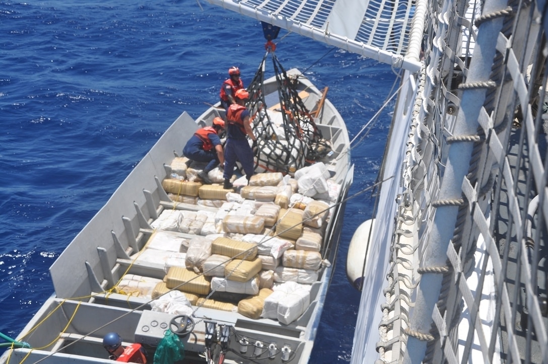 Coast Guardsmen from the Coast Guard Cutter Stratton from Alameda, Calif., unload narcotics from a smuggling vessel intercepted by the crew in the Eastern Pacific Ocean. (Coast Guard photo by Cutter Stratton)