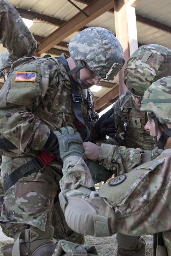 Soldiers of the 316th Sustainment Command (Expeditionary) get into their gunner harness for the humvee egress assistance trainer (HEAT) at Fort Hood, Tx., Oct. 26, 2016. (U.S. Army photo by Staff Sgt. Dalton Smith)