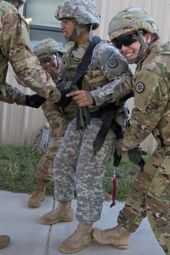 Soldiers of the 316th Sustainment Command (Expeditionary) get into their gunner harness for the humvee egress assistance trainer (HEAT) at Fort Hood, Tx., Oct. 26, 2016. (U.S. Army photo by Staff Sgt. Dalton Smith)