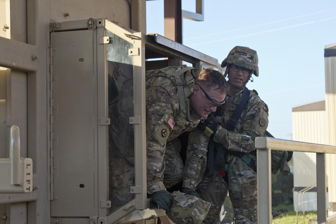 Soldiers of the 316th Sustainment Command (Expeditionary) egress from a humvee egress assistance trainer (HEAT) at Fort Hood, Tx., Oct. 26, 2016. (U.S. Army photo by Staff Sgt. Dalton Smith)