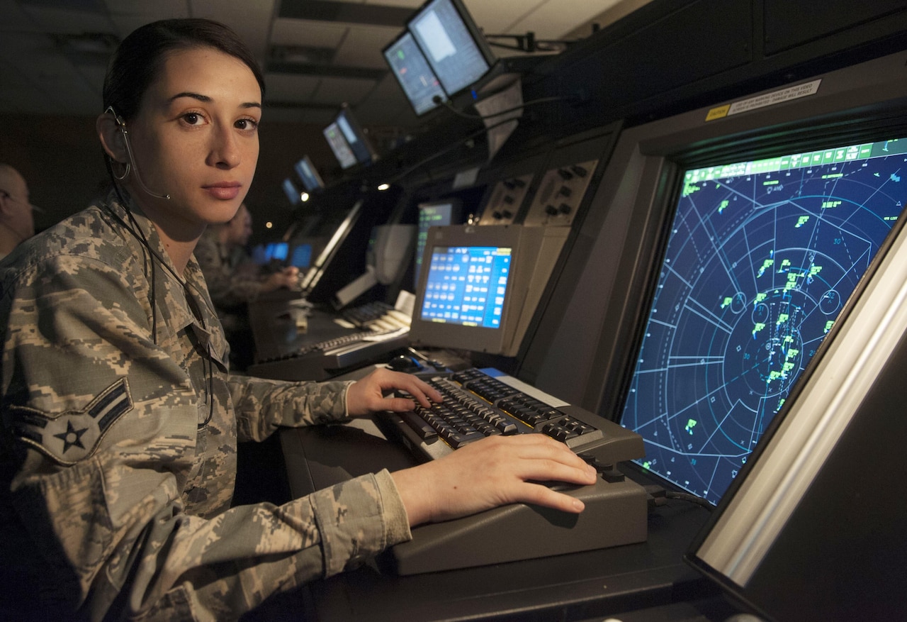 Air Force Airman 1st Class Giorgia Repici, an air traffic controller with the 71st Operations Support Squadron, poses for a photo in the radar approach control facility at Vance Air Force Base, Okla., Oct. 4, 2016. Repici grew up listening to her father tell stories about his adventures as a C-130J Super Hercules pilot in the Italian air force. Air Force photo by Tech. Sgt. Nancy Falcon