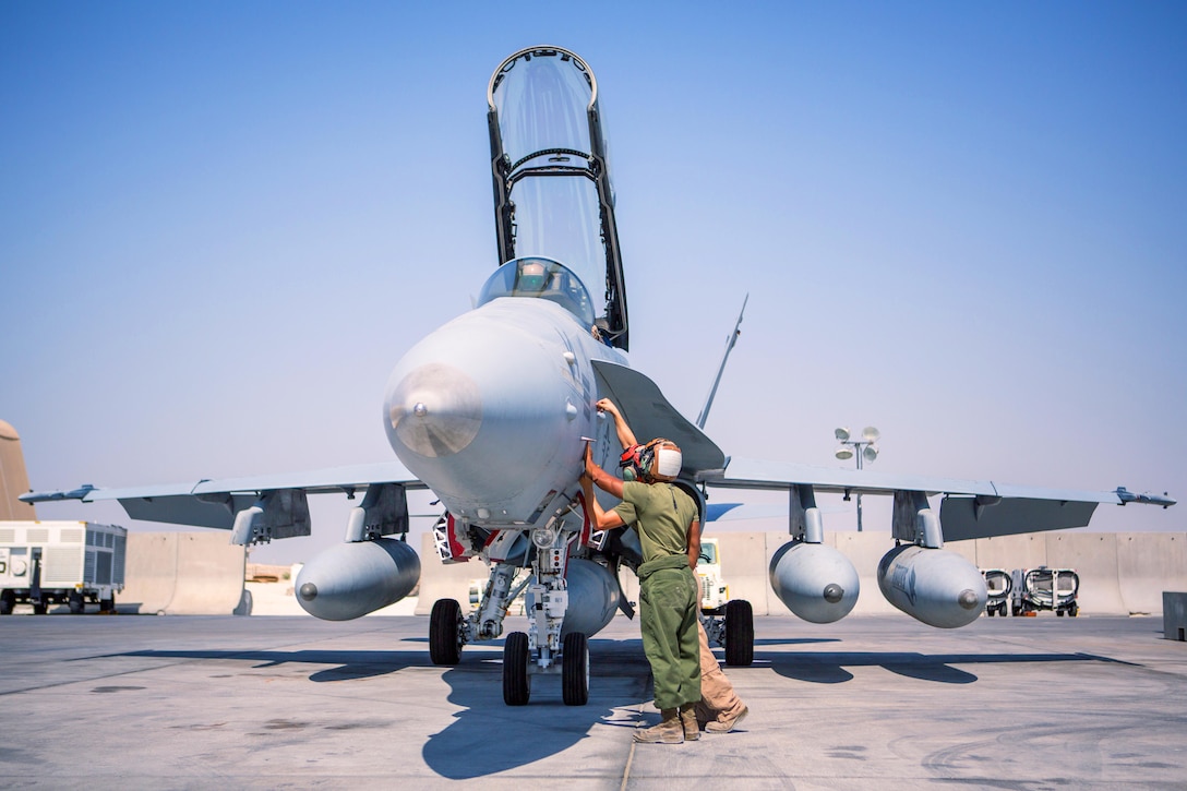 U.S. Marines with Marine All-Weather Fighter Attack Squadron 533, Special Purpose Marine Air-Ground Task Force - Crisis Response - Central Command 16.2, inspect an F/A-18D before takeoff at an undisclosed location in Southwest Asia, Oct. 15, 2016. VMFA(AW)-533 departed the CENTCOM area of responsibility, completing deployment as part of the Aviation Combat Element of SPMAGTF-CR-CC.  The squadron conducted strikes in support of Operation Inherent Resolve, the operation to eliminate the ISIL terrorist group and the threat they pose to Iraq, Syria, and the wider international community. (U.S. Marine Corps photo by Sgt. Donald Holbert)
