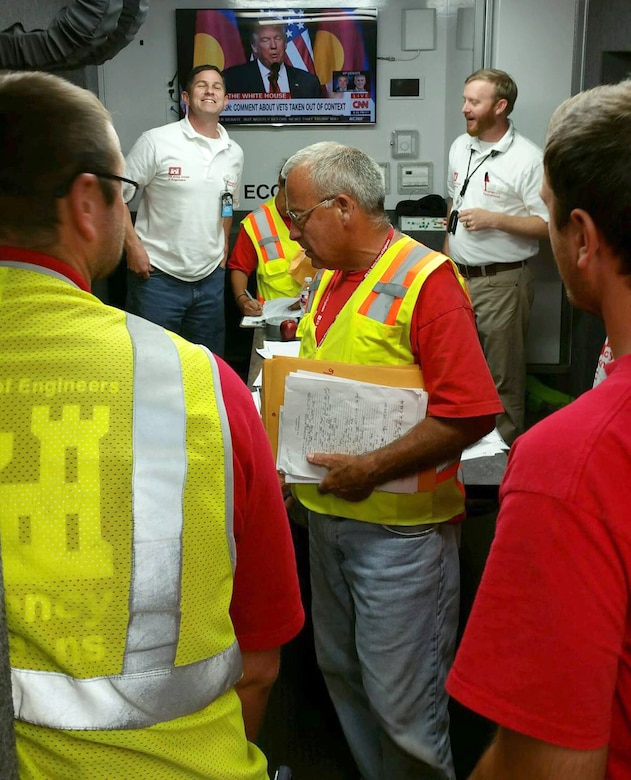 Darren Mulford, back left, and Wes Trammell meet in the Deployable Tactical Operations System while deployed to support flood recovery in Baton Rouge, Louisiana.  The two are members of the U.S. Army Engineering and Support Center, Huntsville's Housing Planning and Response Team.
