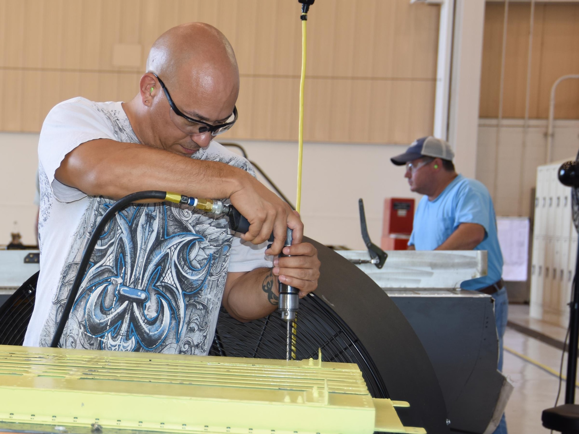 Daniel Blanco, 574th Commodities Maintenance Squadron sheet metal mechanic, works on the C-5 forward ramp floorboard. (U.S. Air Force photo by Ed Aspera)