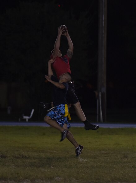 Joseph Passano, 2nd Maintenance Squadron football team wide receiver, leaps to make a catch at Barksdale Air Force Base, La., Oct. 25, 2016. Passano would find the endzone after coming down with the catch. (U.S. Air Force photo/Airman 1st Class Stuart Bright)