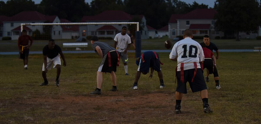 Jerod Weddle, 2nd Maintenance Squadron football team quarterback, receives the snap from his center at Barksdale Air Force Base, La., Oct. 25, 2016. Weddle threw all of his team’s touchdowns during the game. (U.S. Air Force photo/Airman 1st Class Stuart Bright)