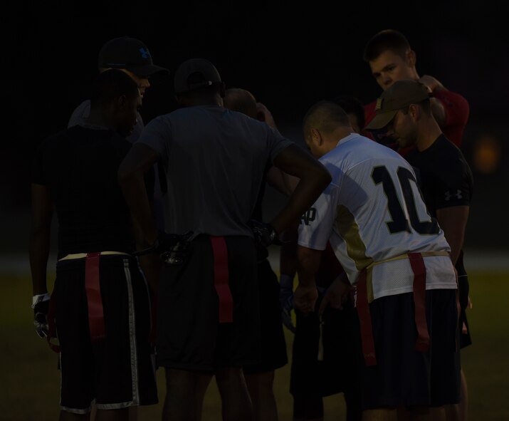 The 2nd Maintenance Squadron football team huddles up to discuss their next play at Barksdale Air Force Base, La., Oct. 25, 2016. The offense would score a touchdown on every one of their drives. (U.S. Air Force photo/Airman 1st Class Stuart Bright)