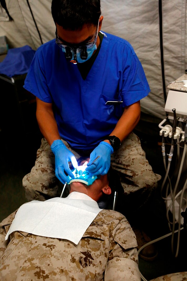 U.S. Navy Lt. Rodney Martin examines a patient who is set to get a tooth filling during the Authorized Dental Allowance List Exercise at Camp Pendleton, Calif., from October 24-28, 2016. The purpose of ADALEX is to familiarize the Sailors of 1st Dental Bn. with their expeditionary equipment and prepare them for operating in a deployed environment. Martin is a dental officer with 1st Dental Battalion, 1st Marine Logistics Group. (U.S. Marine Corps photo by Lance Cpl. Jocelyn Ontiveros)