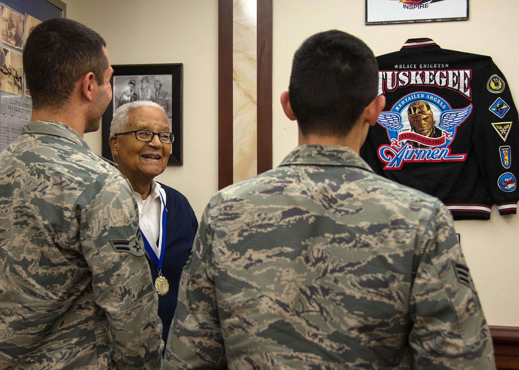 Retired Col. Charles E. McGee, an original Tuskegee Airman, speaks with Airmen during a visit to Hanscom Air Force Base, Mass., Oct. 27. Senior Airman Alfredo Maldonado, right, and Airman 1st Class Quinton Coke, both personnelist with the 66th Force Support Squadron, and other Airmen from Hanscom, met with McGee who spoke about lessons learned, Air Force history and challenged each Airmen to believe in themselves. (U.S. Air Force photo by Mark Herlihy)   
