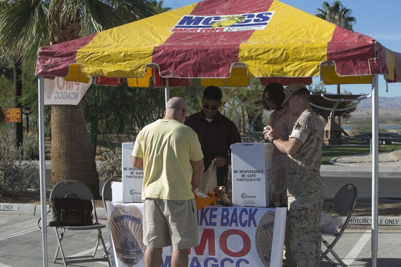 A Marine Corps Air Ground Combat Center resident turns in unused prescription medication to the representatives from the Provost Marshal’s Office’s Drug Take Back at Heritage Park, Oct. 22, 2016. The take back is held to give the Combat Center community the opportunity to anonymously turn in any expired or unneeded prescription drugs for proper disposal. (Official Marine Corps photo by Cpl. Thomas Mudd/Released)