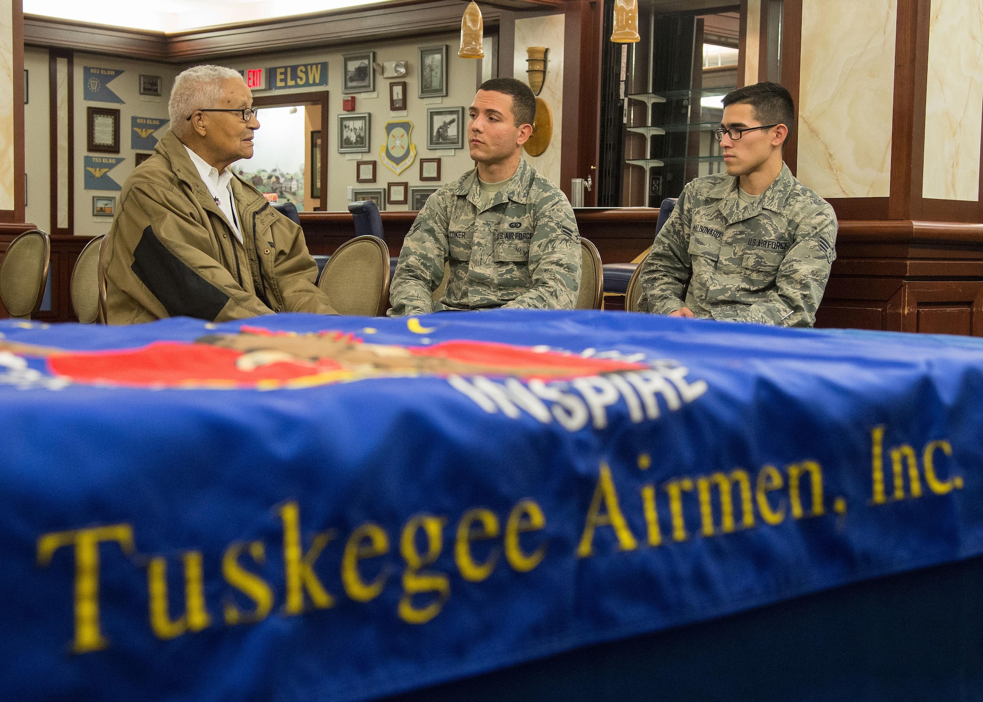 Retired Col. Charles E. McGee, an original Tuskegee Airman, speaks with Senior Airman Alfredo Maldonado, right, and Airman 1st Class Quinton Coke, both personnelist with the 66th Force Support Squadron, during a visit to Hanscom Air Force Base, Mass., Oct. 27. McGee met with Airmen prior to speaking at an event in Boston co-hosted by the New England Tuskegee Airmen Chapter and the local chapter bearing his name. (U.S. Air Force photo by Mark Herlihy)   