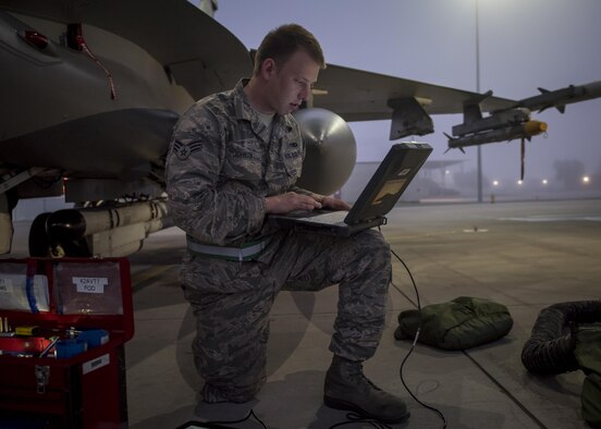 Senior Airman Jeremy Johnson, from the Oklahoma Air National Guard’s 138th Aircraft Maintenance Squadron in Tulsa, Okla., performs routine maintenance on an F-16 Fighting Falcon's critical components Oct. 27, 2016. (U.S. Air Force photo/Drew Egnoske)