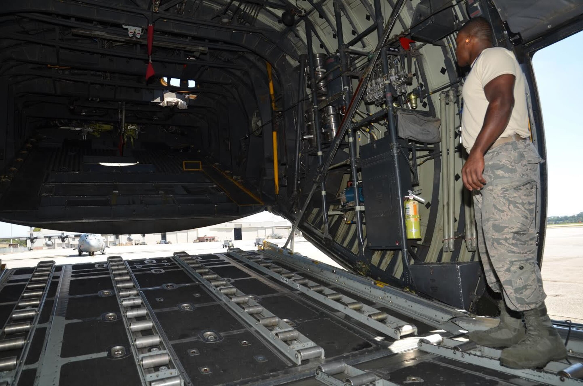 Staff Sgt. Malcolm Young, 94th Aircraft Maintenance Squadron hydraulics specialist, opens the rear ramp of a C-130 on the flight line at Dobbins Air Reserve Base, Georgia on September 29, 2016. Young is responsible for equipment in which hydraulic power is needed such as flight controls, landing gear, steering, brakes, etc. (U.S. Air Force photo by Senior Airman Lauren Douglas) 