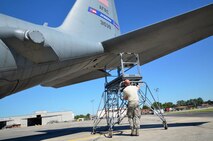 Staff Sgt. John McDermott, 94th Maintenance Squadron avionics instruments and flight control, moves a maintenance ladder used to reach C-130 engines at Dobbins Air Reserve Base on September 28, 2016. Maintenance members sometimes shade their eyes from the sun during a clear day. (U.S. Air Force photo by Senior Airman Lauren Douglas)