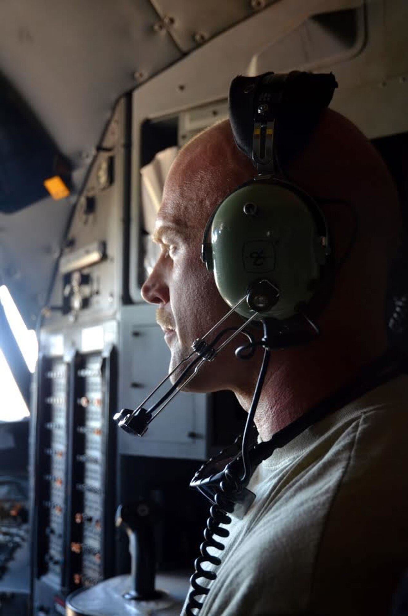 Staff Sgt. John McDermott, 94th Maintenance Squadron avionics instruments and flight control, observes an engine test from the flight deck to ensure repairs are effective at Dobbins Air Reserve Base on September 28, 2016. The maintainers wear headphones to communicate with one another while the thunderous engines are running. (U.S. Air Force photo by Senior Airman Lauren Douglas)