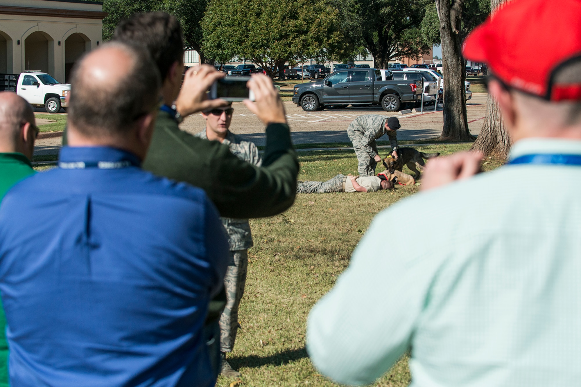A group of civic leaders watch a 2nd Security Forces Squadron working dog demonstration during a tour of Barksdale Air Force Base, La., Oct. 27, 2016. The tour was hosted by the 433rd Airlift Wing from Lackland Air Force Base, Texas, and travel to Barksdale to get first hand look at the different missions throughout the Air Force Reserve Command. (U.S. Air Force photo by Master Sgt. Greg Steele/Released)