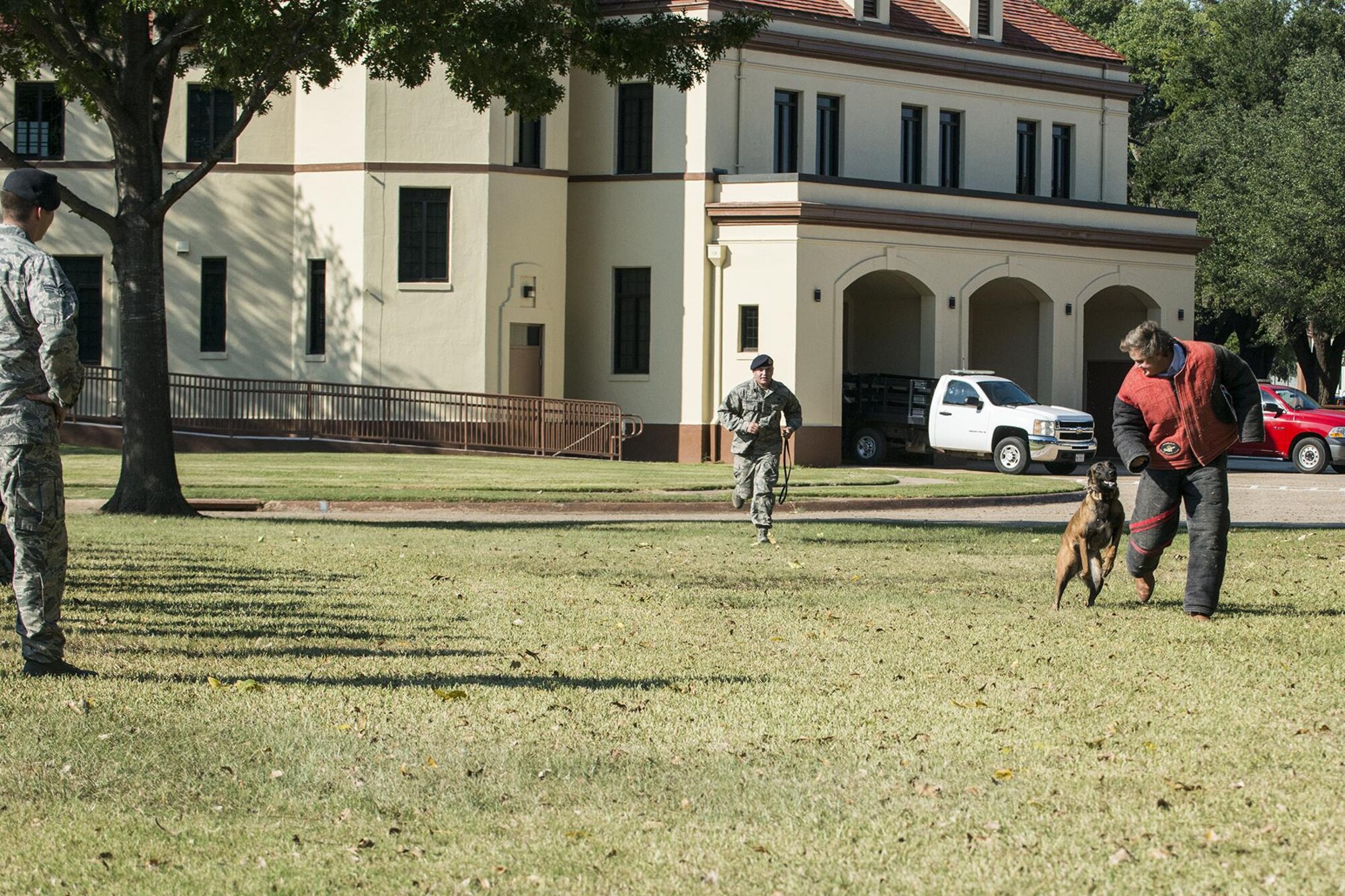 A member of a civic leader group is about to experience the takedown power of a 2nd Security Forces Squadron working dog during a demonstration at Barksdale Air Force Base, La., Oct. 27, 2016. The tour was hosted by the 433rd Airlift Wing from Lackland Air Force Base, Texas, and travel to Barksdale to get first hand look at the different missions throughout the Air Force Reserve Command. (U.S. Air Force photo by Master Sgt. Greg Steele/Released)