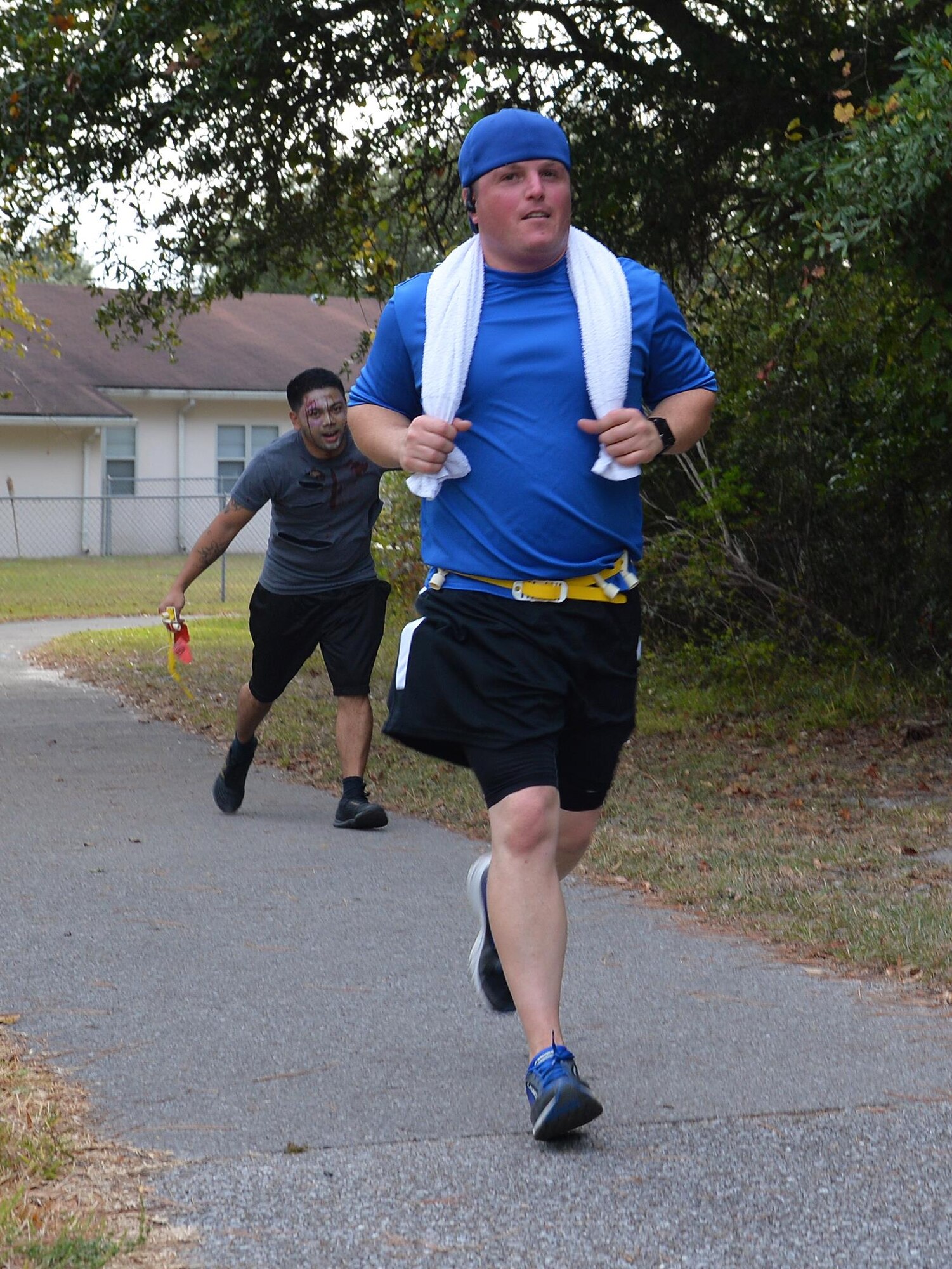 Sean Mullaney runs from zombiefied Air Commandos during the Fear the Running Dead Race at Hurlburt Field, Fla., Oct. 27, 2016. For the race, the 1st Special Operations Force Support staff challenged Airmen to outrun zombies during a 3.1 mile “zombie apocalypse.” (U.S. Air Force photo by Senior Airman Andrea Posey)