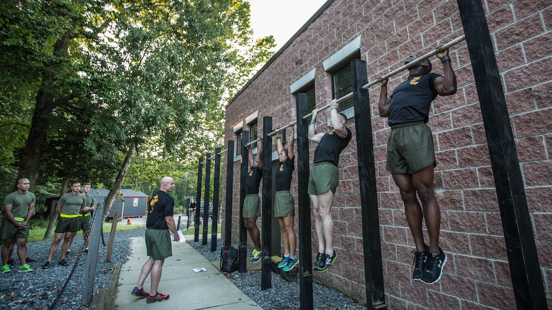 Force Fitness Instructor (FFI) Trainers demonstrate proper pull-up technique for the class of FFI students before executing practical application as part of their course requirement at Marine Corps Base Quantico, Virginia, October 3, 2016. The FFI course is made up of physical training, classroom instruction and practical application to provide the students with a holistic approach to fitness. Upon completion, the Marines will return to serve as unit FFIs, capable of designing individual and unit-level holistic fitness programs. 