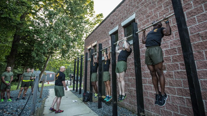 Force Fitness Instructor (FFI) Trainers demonstrate proper pull-up technique for the class of FFI students before executing practical application as part of their course requirement at Marine Corps Base Quantico, Virginia, October 3, 2016. The FFI course is made up of physical training, classroom instruction and practical application to provide the students with a holistic approach to fitness. Upon completion, the Marines will return to serve as unit FFIs, capable of designing individual and unit-level holistic fitness programs. 