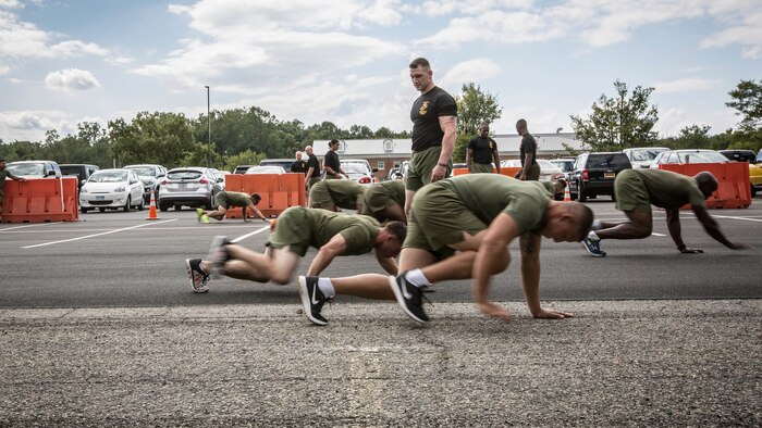 A Force Fitness Instructor (FFI) Trainer monitors the class of FFI students conducting bear crawls during the physical training portion of their course requirement at Corps Base Quantico, Virginia, October 3, 2016. The FFI course is made up of physical training, classroom instruction and practical application to provide the students with a holistic approach to fitness. Upon completion, the Marines will return to serve as unit FFIs, capable of designing individual and unit-level holistic fitness programs.