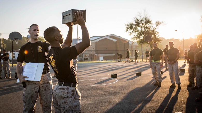 Force Fitness Instructor (FFI) Trainers demonstrate proper ammo can lift technique for the class of FFI students before executing practical application as part of their course requirement at Marine Corps Base Quantico, Virginia, October 4, 2016. The FFI course is made up of physical training, classroom instruction and practical application to provide the students with a holistic approach to fitness. Upon completion, the Marines will serve as unit FFIs, capable of designing individual and unit-level holistic fitness programs.  