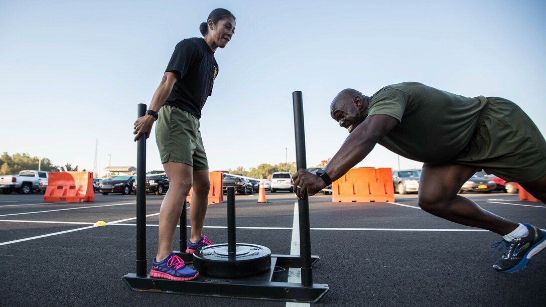 A Force Fitness Instructor (FFI) Trainer coaches an FFI student during the physical training portion of the course at Marine Corps Base Quantico, Virginia, October 17, 2016. The FFI course is made up of physical training, classroom instruction and practical application to provide the students with a holistic approach to fitness. Upon completion, the Marines will 
serve as unit FFIs, capable of designing individual and unit-level holistic fitness programs.  
