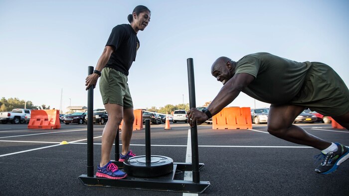 A Force Fitness Instructor (FFI) Trainer coaches an FFI student during the physical training portion of the course at Marine Corps Base Quantico, Virginia, October 17, 2016. The FFI course is made up of physical training, classroom instruction and practical application to provide the students with a holistic approach to fitness. Upon completion, the Marines will 
serve as unit FFIs, capable of designing individual and unit-level holistic fitness programs.  
