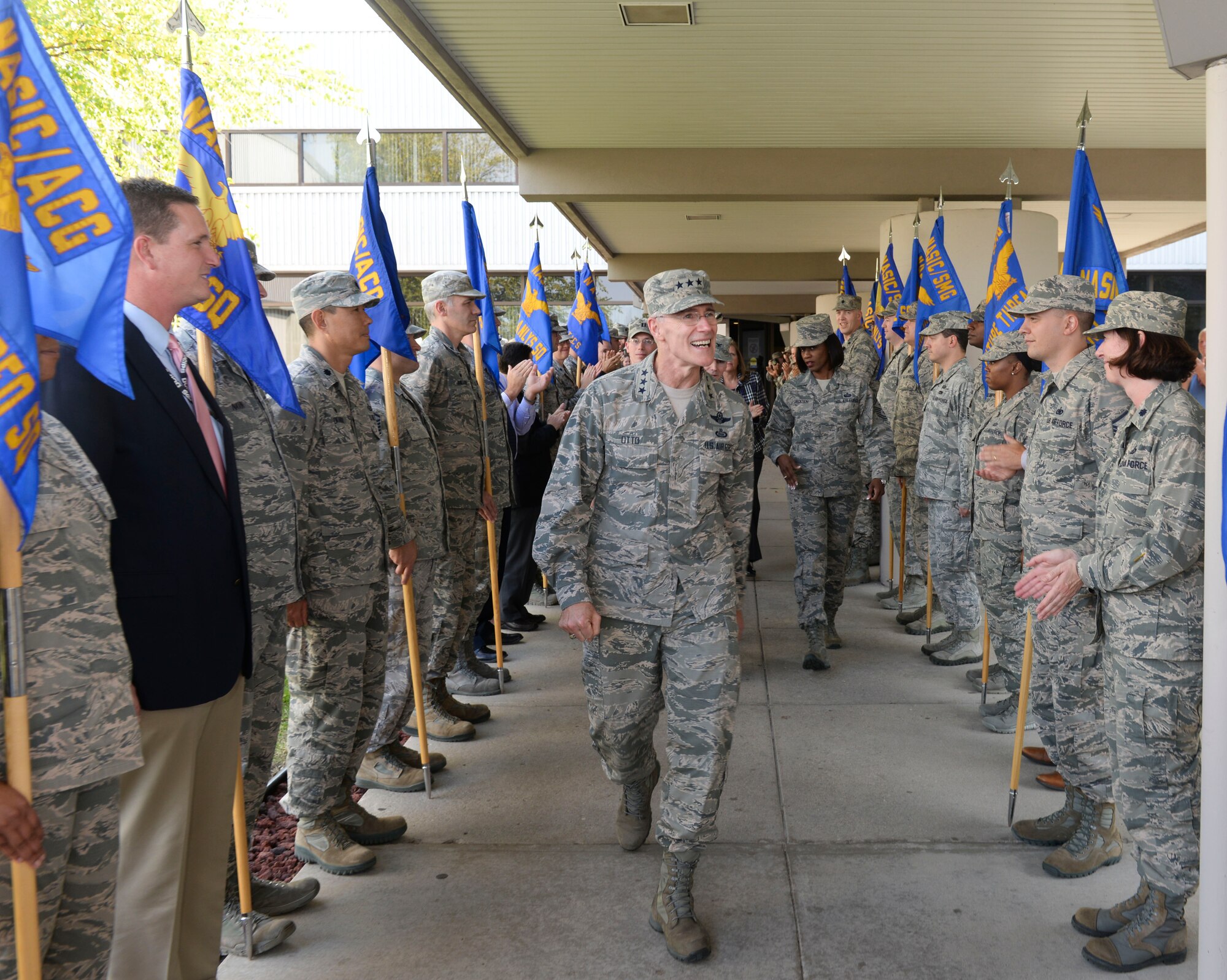 Lt. Gen. Robert Otto, Deputy Chief of Staff for Intelligence, Surveillance and Reconnaissance, Headquarters U.S. Air Force, Washington, D.C., leaves the National Air and Space Intelligence Center through a tunnel of cheering NASIC Airmen Oct. 12, 2016, at Wright-Patterson Air Force Base, Ohio. Otto is responsible to the Secretary and Chief of Staff of the Air Force for policy formulation, planning, evaluation, oversight, and leadership of Air Force intelligence, surveillance and reconnaissance capabilities. He will retire from the Air Force November 2016 after 34 years of dedicated service. NASIC is a Field Operating Agency that reports to HAF/A2. (Air Force photo by: Senior Airmen Samuel Earick)