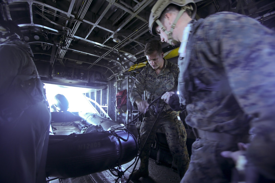 Marines detach a zodiac boat from a CH-53E Super Stallion helicopter before jumping into ocean waters during a helocasting exercise at Camp Lejeune, N.C., Oct. 20, 2016. Helocasting is a means of insertion for sea to shore reconnaissance operations. The Marines are with 2nd Reconnaissance Battalion. (U.S. Marine Corps photo by Lance Cpl. Miranda Faughn)