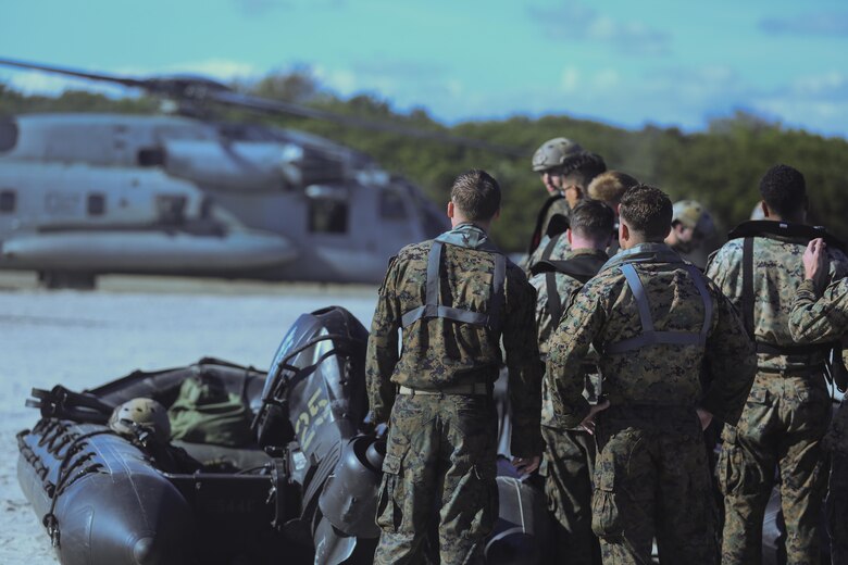 Marines wait to load a zodiac boat onto a CH-53E Super Stallion during a helocasting exercise at Camp Lejeune, N.C., Oct. 20, 2016.  Helocasting is a means of insertion for sea to shore reconnaissance operations. The Marines are with 2nd Reconnaissance Battalion. (U.S. Marine Corps photo by Lance Cpl. Miranda Faughn)