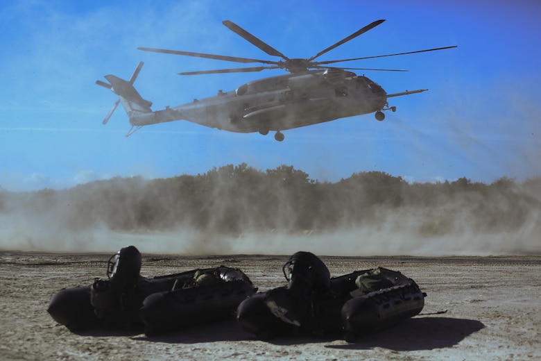A CH-53E Super Stallion carries Marines out to sea to drop them into the surf during a helocasting exercise at Camp Lejeune, N.C., Oct. 20, 2016. During the helocasting the Marines practiced detaching a zodiac boat from inside a CH-53, jumping after it, and then working as a team to get into the zodiac and bring it back to shore. The Marines are with 2nd Reconnaissance Battalion. (U.S. Marine Corps photo by Lance Cpl. Miranda Faughn)