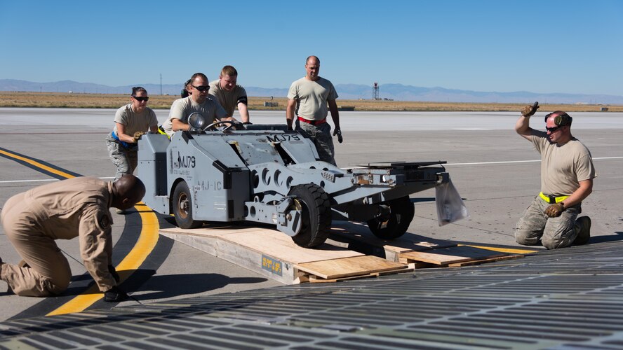 Airmen assigned to the 366th Logistics Readiness Squadron and the 60th Air Mobility Wing assist a munitions loader onto a C-5 Galaxy, Sept. 27, 2016, at Mountain Home AIr Force Base, Idaho. Thousands of pounds of equipment were loaded onto the aircraft in preparation for a deployment to Southwest Asia. (U.S. Air Force photo by Senior Airman Connor J. Marth/Released)