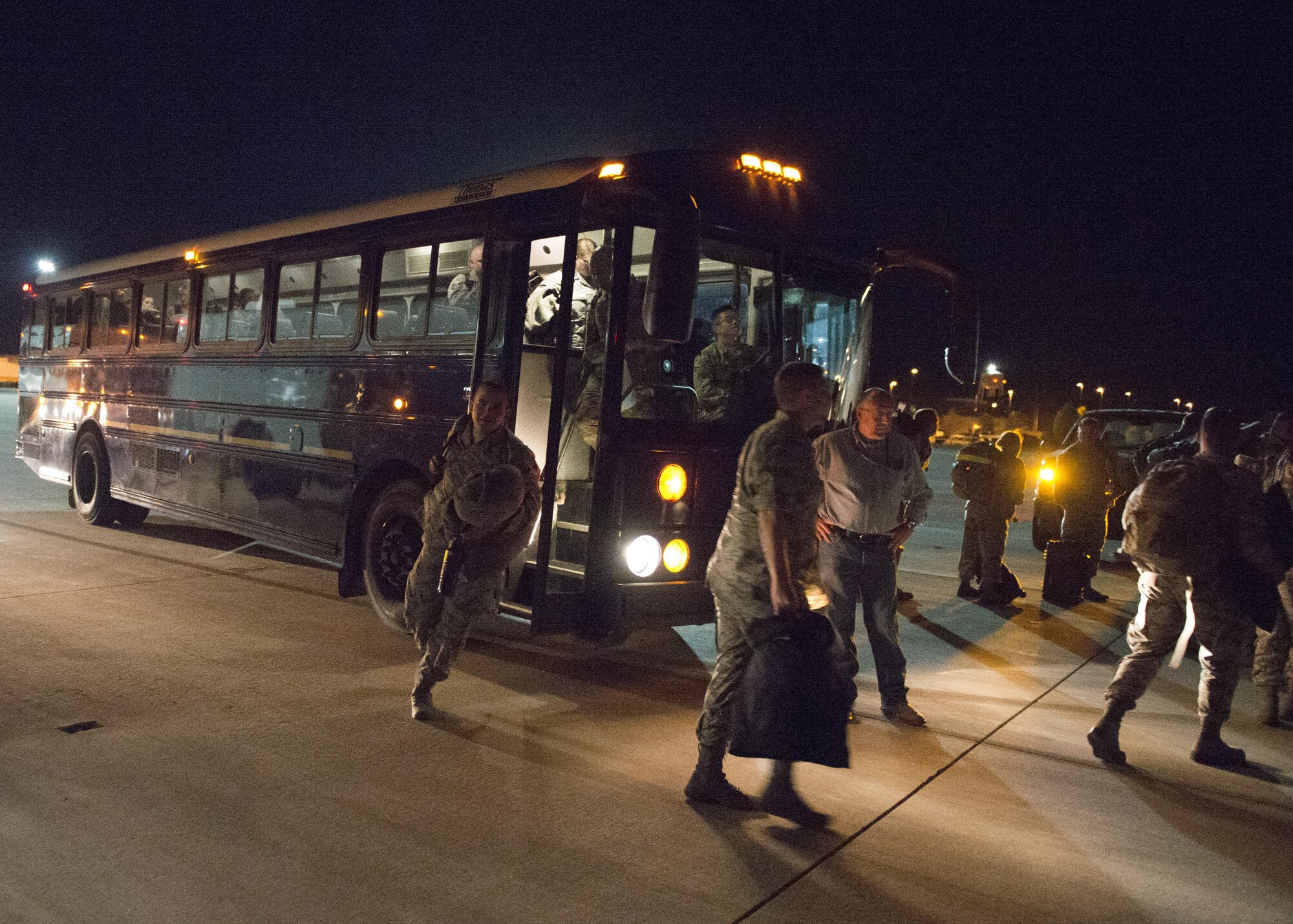Members of the 726th Air Control Squadron depart from buses before boarding a plane to deploy from Mountain Home Air Force Base, Idaho, Oct. 10, 2016. The 726th ACS is a tenant unit stationed at Mountain Home AFB and assigned to the 552nd Air Control Group at Tinker AFB. The squadron is responsible for mobile, decentralized command and control of joint operations by conducting threat warning, battle management, theater missile defense, weapons control, combat identification and strategic communications. (U.S. Air Force photo by Airman 1st Class Chester Mientkiewicz/Released)