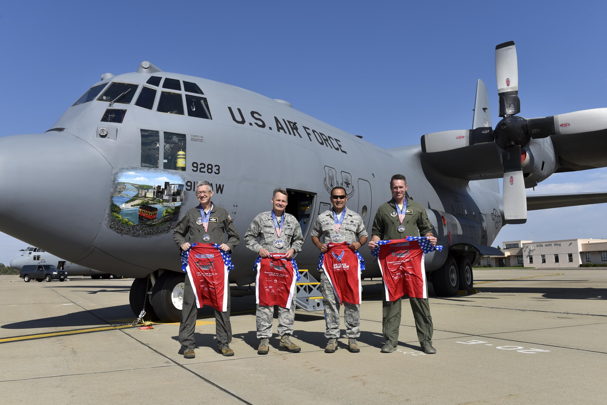 Six members of the Pittsburgh International Airport Air Reserve Station pose with shirts and medals from the U.S. Air Force Marathon at the Pittsburgh IAP ARS October 16, 2016. Five members completed the half marathon and one completed the full marathon. (U.S. Air Force photo by Airman 1st Class Beth Kobily