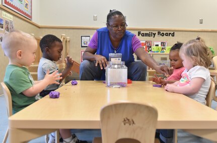 Patricia Bonneau, education technician, teaches children how to use playdough at the Joint Base Charleston Child Development Center, Oct. 24, 2016. The CDC provides daytime care for children of Department of Defense members from six months to five years of age. At the CDC, the children make the playdough used in the center for their learning activities.