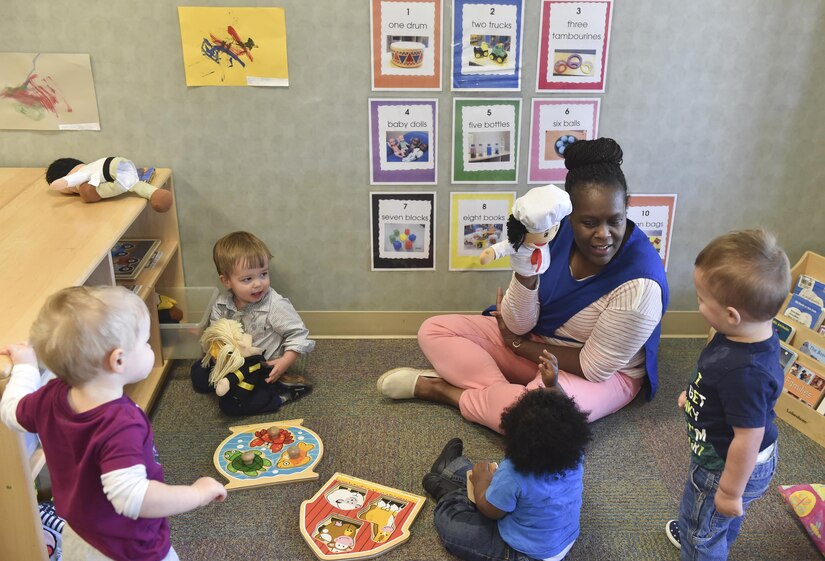 Yolonda Green, education technician, entertains children with a puppet during play time at the Joint Base Charleston Child Development Center, Oct. 24, 2016. The CDC provides daytime care for children of Department of Defense members from six months to five years of age.