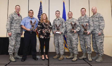 Col. Robert Lyman, Joint Base Charleston commander, left, and Chief Master Sgt. Todd Cole, 628th Air Base Wing (ABW) command chief, right, stand with the 628th ABW third quarter award winners during a ceremony at the Charleston Club Oct. 21, 2016. The winners (left to right) are:  Mr. James Chavis, 628th Civil Engineer Squadron, Ms. Justine Smith, 628th Contracting Squadron, Airman 1st Class Jacques Benoit, 437th Aerial Port Squadron, Master Sgt. Jason Gilbert, 628th Medical Group, and Capt. Charles Keaton, 628th Comptroller Squadron. The 628th ABW quarterly awards recognize outstanding Airmen, NCOs, senior NCOs, company grade officers and civilians for their hard work and dedication. 