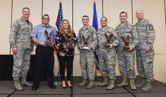 Col. Robert Lyman, Joint Base Charleston commander, left, and Chief Master Sgt. Todd Cole, 628th Air Base Wing (ABW) command chief, right, stand with the 628th ABW third quarter award winners during a ceremony at the Charleston Club Oct. 21, 2016. The winners (left to right) are:  Mr. James Chavis, 628th Civil Engineer Squadron, Ms. Justine Smith, 628th Contracting Squadron, Airman 1st Class Jacques Benoit, 437th Aerial Port Squadron, Master Sgt. Jason Gilbert, 628th Medical Group, and Capt. Charles Keaton, 628th Comptroller Squadron. The 628th ABW quarterly awards recognize outstanding Airmen, NCOs, senior NCOs, company grade officers and civilians for their hard work and dedication. 