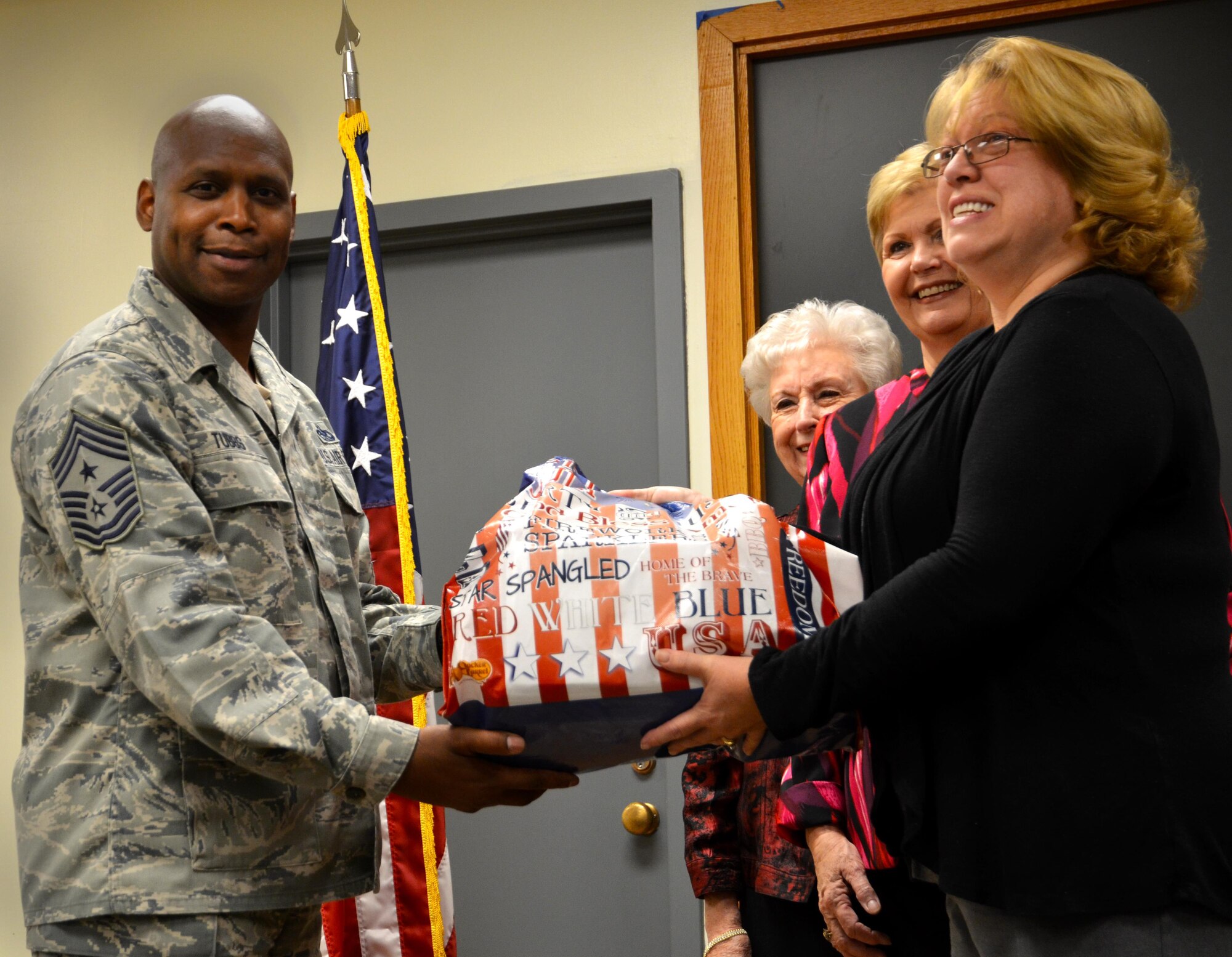 Chief Lyndon Tubbs, 94th Airlift Wing command chief, receives a donation of cards from Helen Skelton, Order of Eastern Star Grand Chapter of Georgia chairperson of operation at Dobbins Air Reserve Base, Georgia on October 25, 2016. The Eastern Stars gave over 10,000 cards to be sent to troops that may not be in the company of family this holiday. (U.S. Air Force photo by Senior Airman Lauren Douglas)