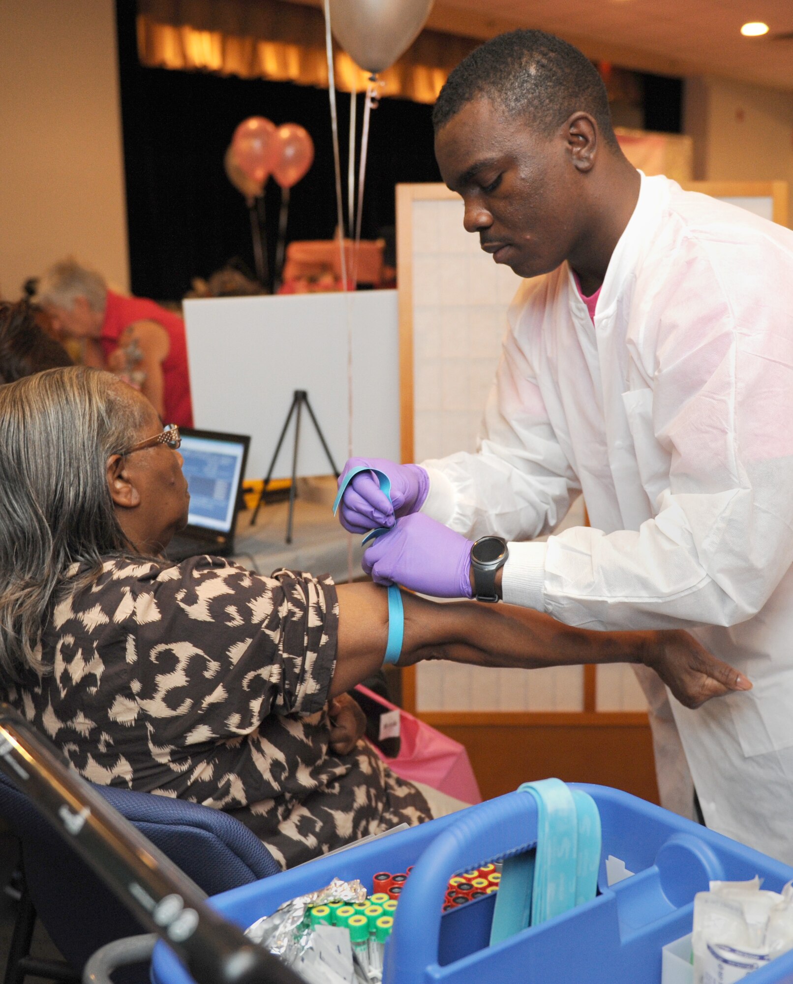 Mamie Chatman, spouse of retired Chief Master Sgt. Roscoe Chatman, prepares to have her blood drawn by Airman 1st Class Isaiah Jones, 81st Diagnostic and Therapeutics Squadron lab technician, during the 5th Annual Mammothon Cancer Screening and Preventative Health Fair at the Don Wylie Auditorium Oct. 28, 2016, on Keesler Air Force Base, Miss. The walk-in event included screenings for multiple types of cancer and chronic diseases in honor of Breast Cancer Awareness Month. Flu shots were also provided upon request. (U.S. Air Force photo by Kemberly Groue/Released)