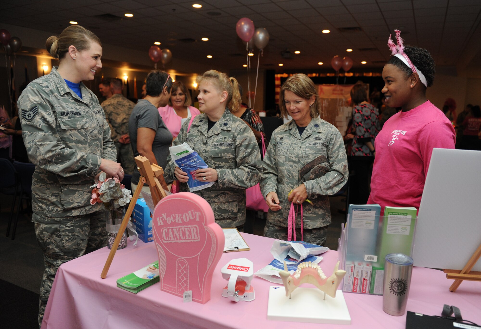 Keesler personnel visit the 81st Dental Squadron booth during the 5th Annual Mammothon Cancer Screening and Preventative Health Fair at the Don Wylie Auditorium Oct. 28, 2016, on Keesler Air Force Base, Miss. The walk-in event included screenings for multiple types of cancer and chronic diseases in honor of Breast Cancer Awareness Month. Flu shots were also provided upon request. (U.S. Air Force photo by Kemberly Groue/Released)