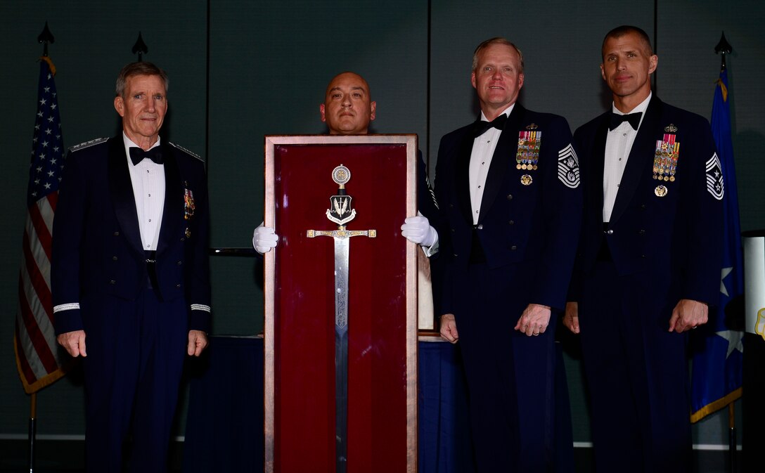 Gen. Hawk Carlisle, commander of Air Combat Command, left, is presented with an Order of the Sword shadowbox by Chief Master Sgt. Jose A. Baraza, 12th Air Force command chief, Davis-Monthan Air Force Base, Ariz., Chief Master Sgt. of the Air Force James Cody and Chief Master Sgt. Steve K. McDonald, ACC command chief, during an Order of the Sword Ceremony at the Hampton Roads Convention Center in Hampton, Va., Oct. 27, 2016. Carlisle, who has commanded ACC since October 2014, is the eighth ACC leader to be inducted into the command's Order of the Sword. (U.S. Air Force photo by Airman 1st Class Kaylee Dubois)