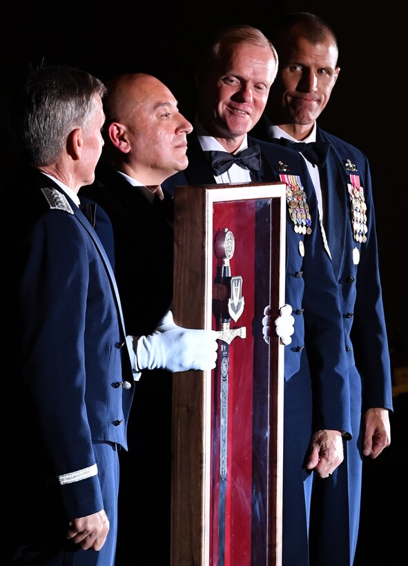 Gen. Hawk Carlisle, commander of Air Combat Command, is presented with an Order of the Sword shadowbox by Chief Master Sgt. Jose A. Baraza, 12th Air Force command chief, Davis-Monthan Air Force Base, Ariz., Chief Master Sgt. of the Air Force James Cody and Chief Master Sgt. Steve K. McDonald, ACC command chief, during an Order of the Sword Ceremony at the Hampton Roads Convention Center in Hampton, Va., Oct. 27, 2016. Carlisle, who has commanded ACC since October 2014, is the eighth ACC leader to be inducted into the command's Order of the Sword. (U.S. Air Force photo by Staff Sgt. Nick Wilson)
