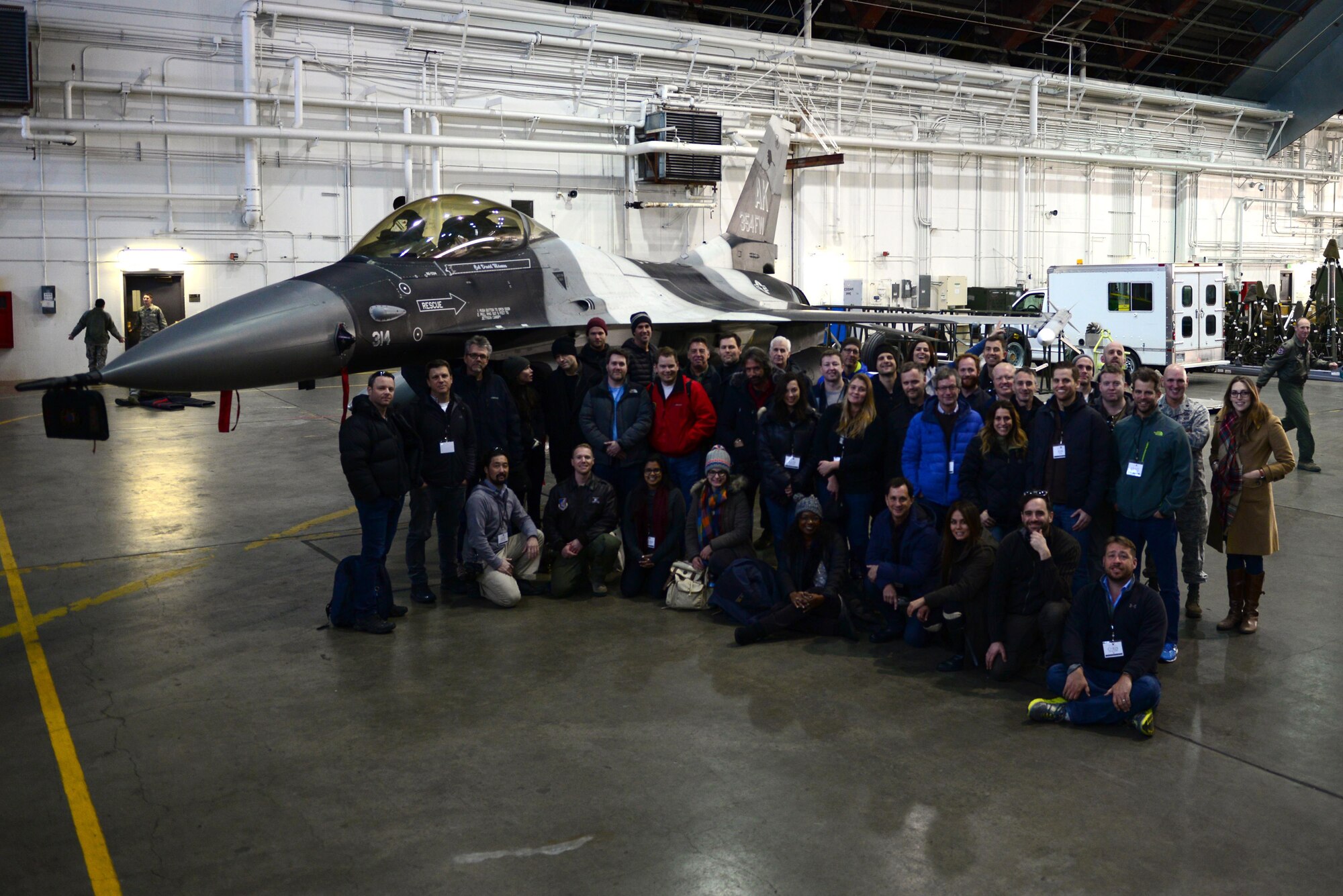Civic leaders pose for a group photo in front of a U.S. Air Force F-16 Fighting Falcon aircraft assigned to the 18th Aggressor Squadron, Oct. 25, 2016, at Eielson Air Force Base, Alaska. During their time in the Thunderdome, civic leaders were able to see the F-16 up-close, try on pilot equipment and observe a military working dog demonstration. (U.S. Air Force photo by Airman Eric M. Fisher)